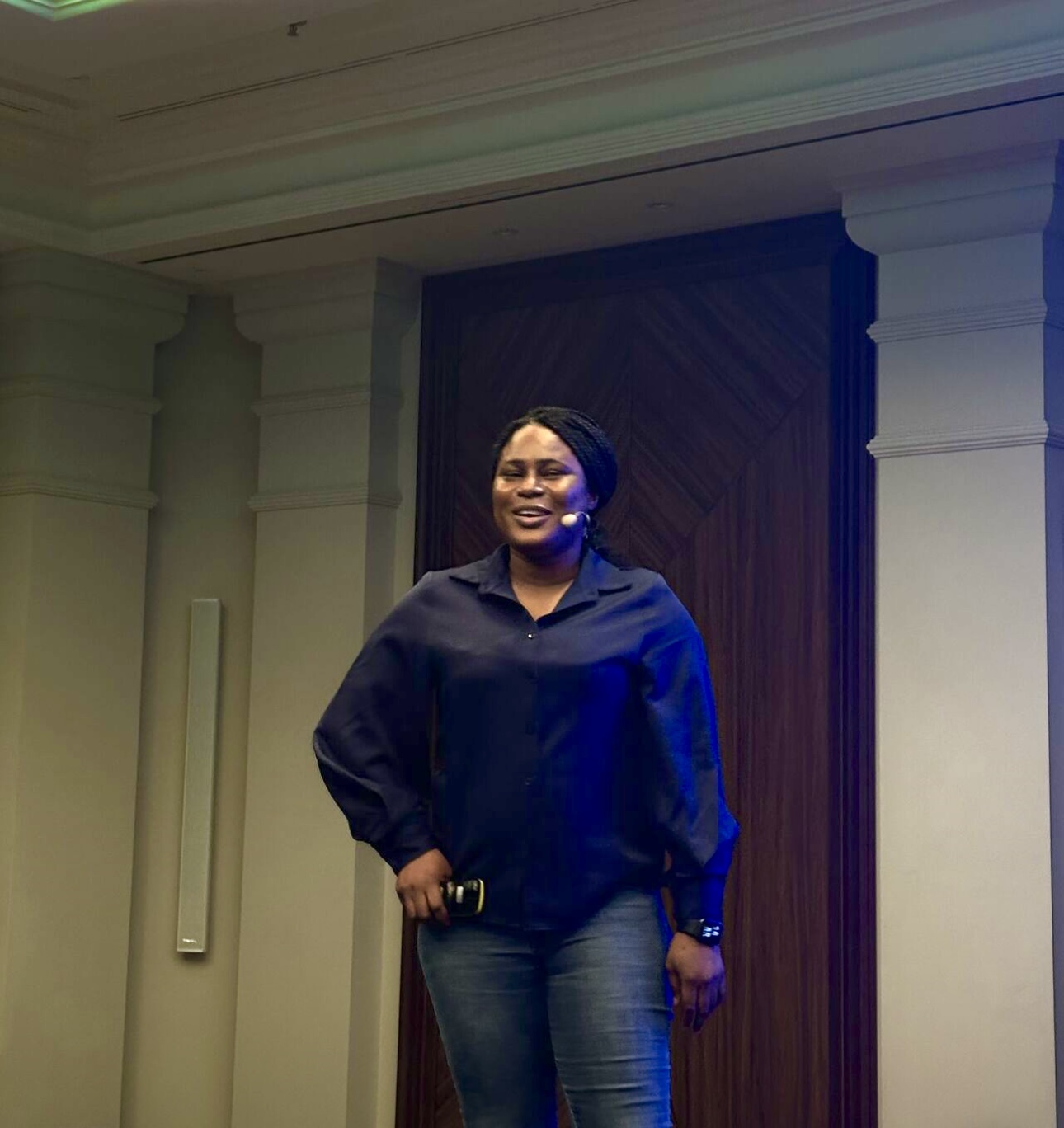 Rachel Irabor speaking on stage at a technology conference